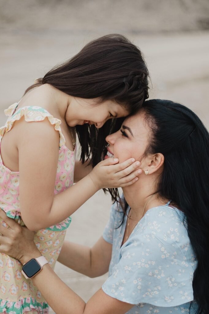 Daughter gently holding her mother’s face – symbolising care, connection, and occupational therapy support for families.